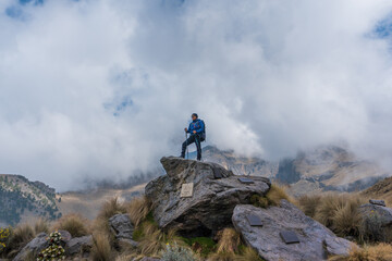 Woman hiker on a top of a mountain