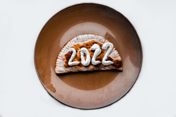  The number 2022 is written with sour cream on a cheburek. New year 2022 is coming soon. High quality photo
