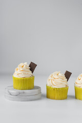 Vanilla cupcakes with white buttercream frosting, plain cupcakes with swirl buttercream, cupcakes in green wrapper
