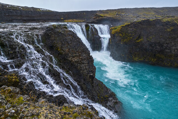 Picturesque waterfall Sigoldufoss autumn view. Season changing in southern Highlands of Iceland.