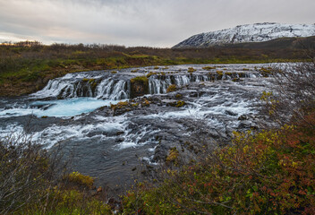 Fototapeta na wymiar Picturesque waterfall Bruarfoss autumn view. Season changing in southern Highlands of Iceland.