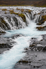Fototapeta premium Picturesque waterfall Bruarfoss autumn view. Season changing in southern Highlands of Iceland.