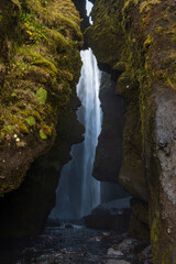 Picturesque Gljufrabui waterfall in the stone cavern autumn view, southwest Iceland.