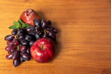 delicious fruits, apples and grapes on wooden table, top view photo with space for text