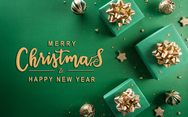 Christmas and new year background concept. Top view of Christmas gift box, christmas ball and snowflake on green background.