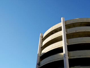 A reinforced concrete helical parking lot with empty blue skies to the left