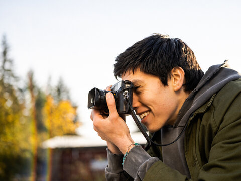 Young Indigenous adult male photographer outdoors