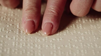 Blind woman reading braille book using fingers close-up, poorly seeing female person learning to read, home education for people with disabilities, touching letters on sheet of paper.