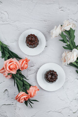Caneles de bordeaux with rose traditional French sweet dessert on white table background. under sunlight. French pastry Canele rum and vanilla flavor thick caramelized crust. 