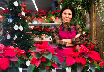 Portrait of successful flower shop owner with crossed arms
