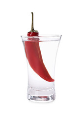 Red hot chili pepper and vodka in shot glass on white background