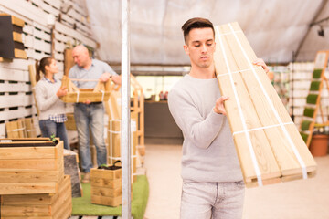 Fototapeta premium Male customer selecting construction materials in hardware store. High quality photo