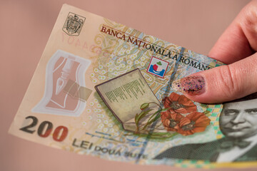 Woman hand giving money like bribe or tips isolated . LEI currency banknotes close up. Reward for...