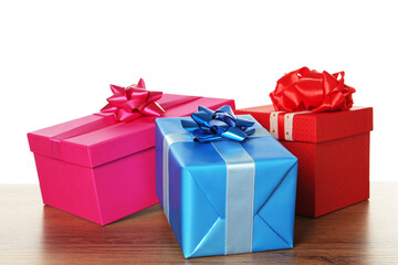 Fototapeta premium Colorful gift boxes on wooden table against white background
