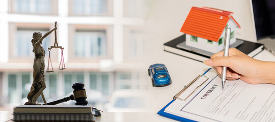 Obraz premium Scales of Justice and Hammer Lawyers and cars and houses. Contact documents. Buying a house, car, real estate approval ideas.