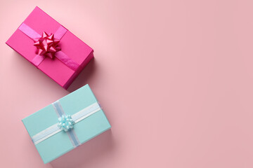 Bright gift boxes on pink background, flat lay. Space for text