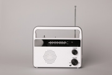 Portable retro radio receiver on grey background