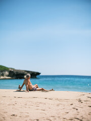 Fototapeta na wymiar Old man enjoying the beach and the sun