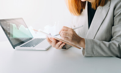 Financial report data of business operations (balance sheet and income statement and diagram) as Fintech concept.Business team meeting. digital tablet and computer laptop.