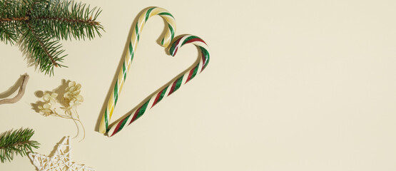 Christmas banner with copy space. Christmas sugar candies and decorations on beige background.