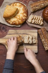 Slicing a baguette on a cutting board.