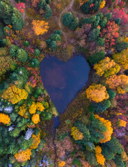 Heart shaped lake in the autumn forest