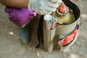 hand preparing the tools for artificial insemination of cow.