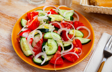 Vegetarian salad with fresh cucumbers, tomatoes, onion and olive oil, nobody