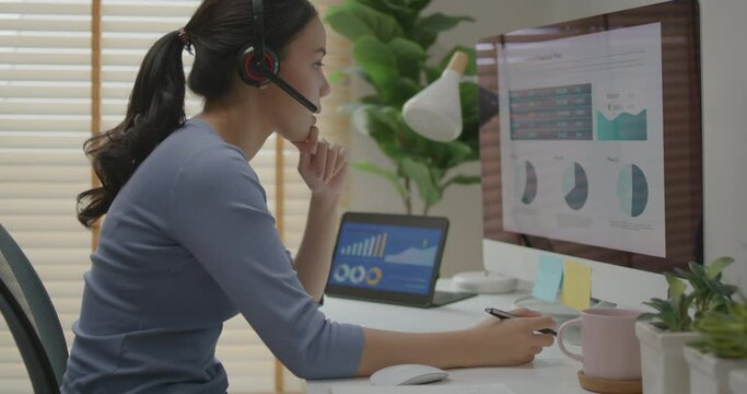 Asia people young casual woman remote work at desk home phone call talk study learn MBA online class. SEO sale plan report data chart graph on desktop PC screen reskill upskill career job workforce.