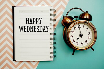 Happy Wednesday text and alarm clock on blue background