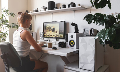 Woman photographer working at white stylish home office workplace drinking coffee ice latte
