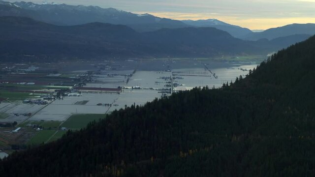 Aerial View Revealing West Canadian Flooding, Mountain Area, Dusk.