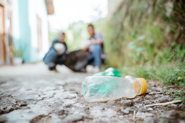 two happy teenage volunteers picking up trash
