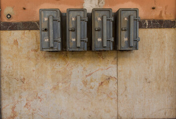 Metal power boxes on wall