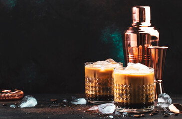 White russian cocktail, trendy alcoholic drink with vodka, coffee liqueur, cream and ice, dark...