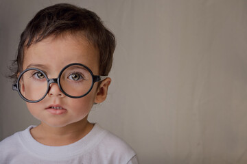 portrait of a smart little boy with big glasses