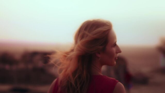 medium close shot on a European girl walking in the desert of UAE
