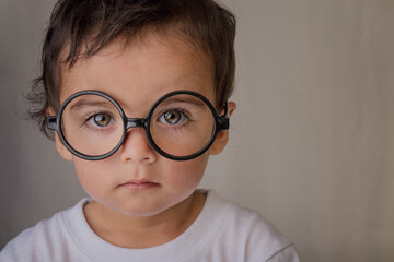 portrait of a smart little boy with big glasses
