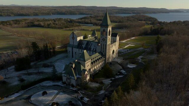 Abbey of Saint Benoit du Lac during Sunset in Late Winter, Quebec, Canada - aerial drone shot
