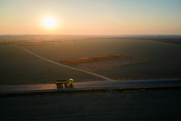 Aerial view of cargo truck driving on highway hauling goods. Delivery transportation and logistics concept