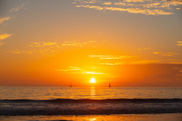 Fototapeta premium Sunset at the sea. Sunrise on beach. Colorful ocean, nature landscape background with copy space.