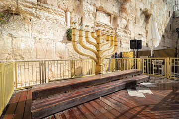A wide-angle view of the huge and traditional golden menorah lying in the Western Wall plaza in...