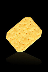 crackers isolated on black reflective background. crispy biscuits