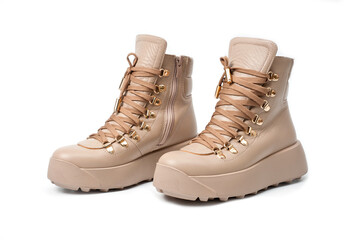 Womens beige leather boots with zip and lacing, photographed against a white background.