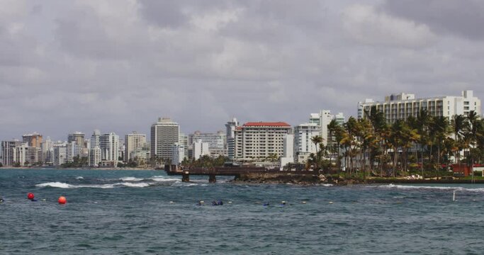 Holiday apartment buildings of Condando Beach, view across El Boqueron Bay, San Juan, Puerto Rico.