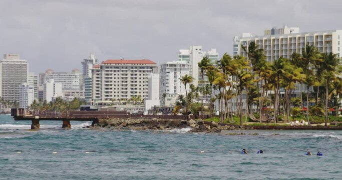 Slow zoom out shot of view across El Boqueron Bay on windy day toward Condando Beach, Puerto Rico.