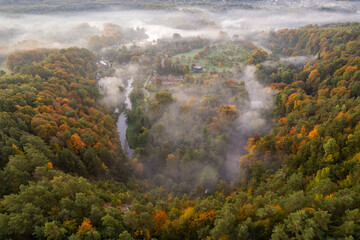 Fototapeta premium Aerial autumn fall sunrise view of foggy forest in Vilnius, Lithuania