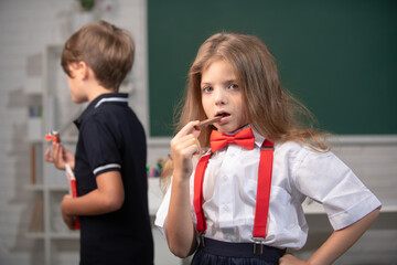 Portrait of attractive cheerful girl eating healthy food or eating chocolate sweets in class at...