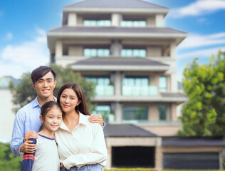 Happy family stand outside before their new house