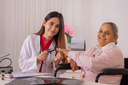 Lady Doctor Checking Blood Sugar Of A Senior Woman